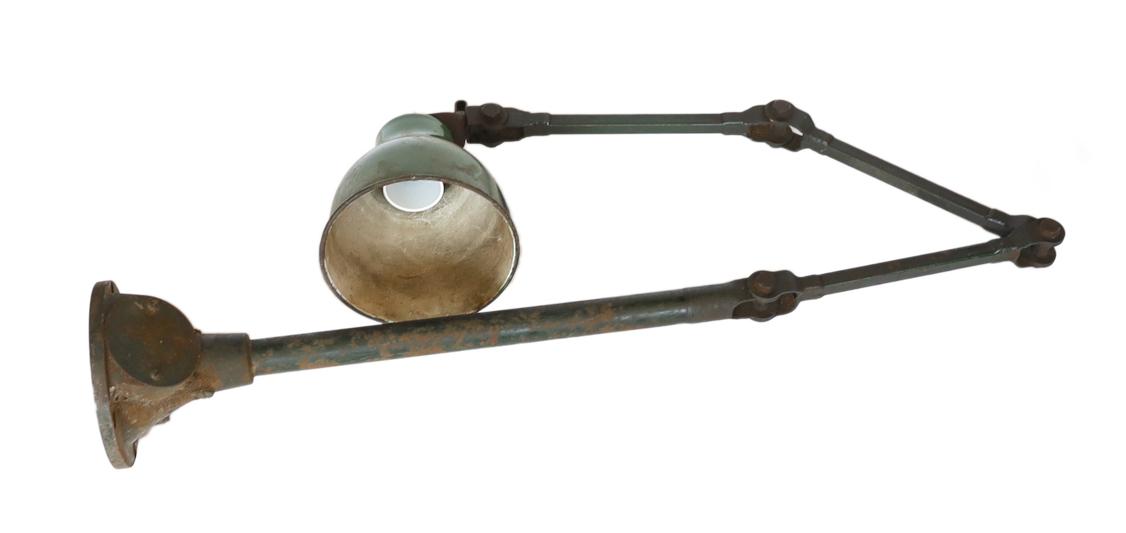A 1920s painted and enamelled metal adjustable machine bench lamp, height 70cm